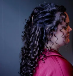 hair styling for wedding - a bride with curly dark hair side profile