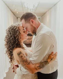 hair styling for wedding - bride with curly long hair and groom with their foreheads touching