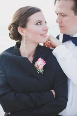 hair styling for wedding - bride with updo wearing grooms jacket